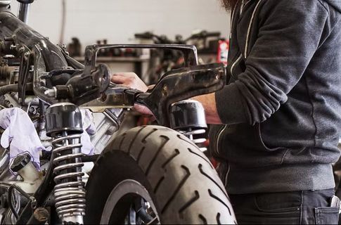 A photo of a man working on an engine in a garage
