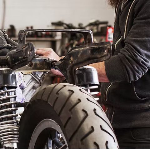 A photo of a man working on an engine in a garage