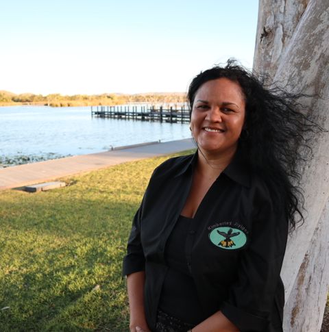 A photo of Natasha Short, a First Nations woman, standing under a tree outside