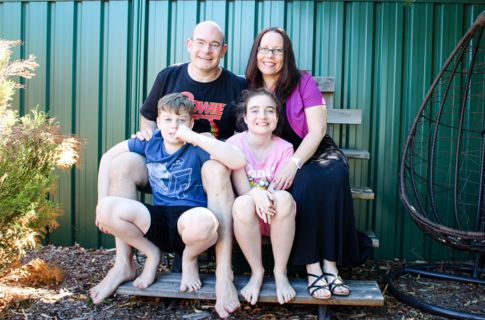 Bolger family sitting outdoors smiling.
