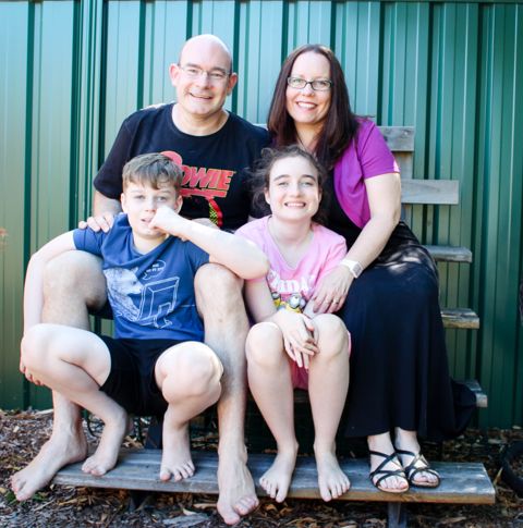 Bolger family sitting outdoors smiling.