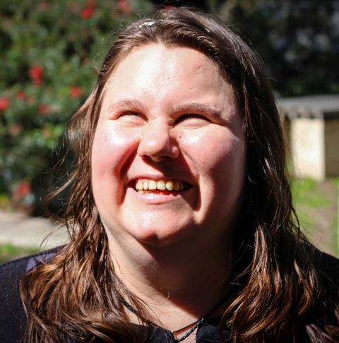 Grace outdoors smiling.