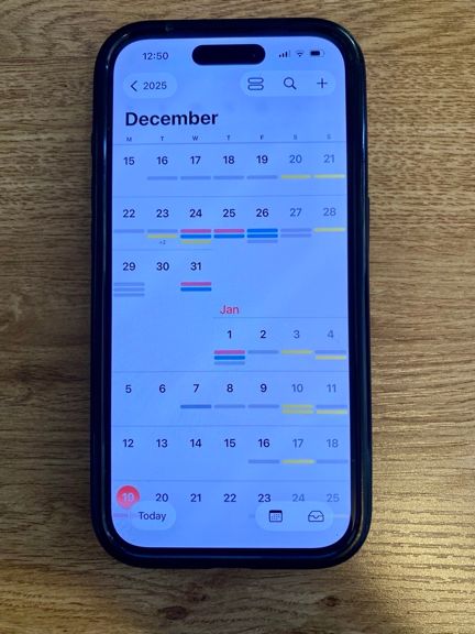 Photo of a phone screen showing a calendar, with the details hidden