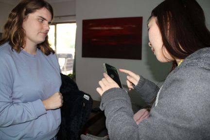 Vision Australia OT Rachael Poon with Emma working out the iPhone text-to-audio