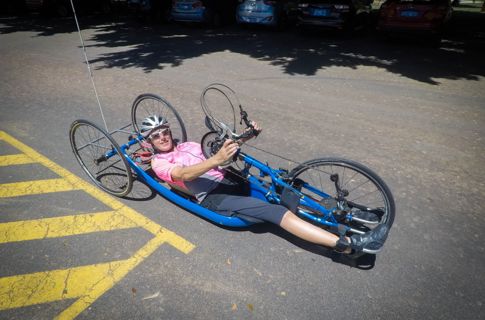 Louise on her tricycle smiling.