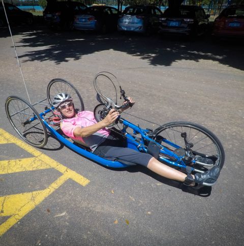 Louise on her tricycle smiling.
