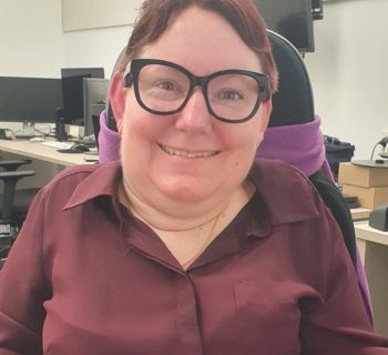 A smiling woman in glasses
