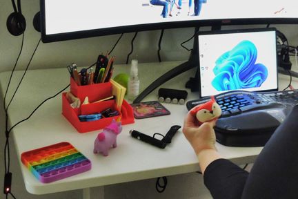 A selection of sensory fidgets, one of which is being used