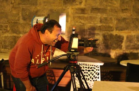 Peter looking through his camera on tripod.
