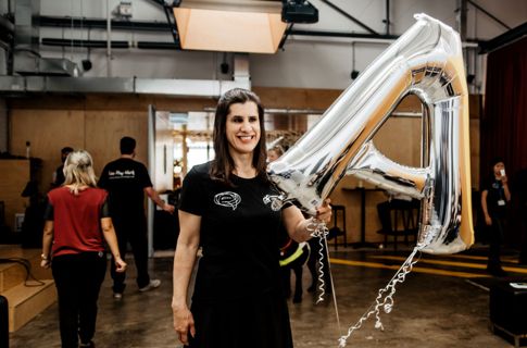 Zel holding balloon and smiling.