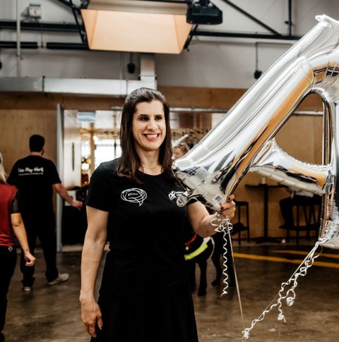 Zel holding balloon and smiling.