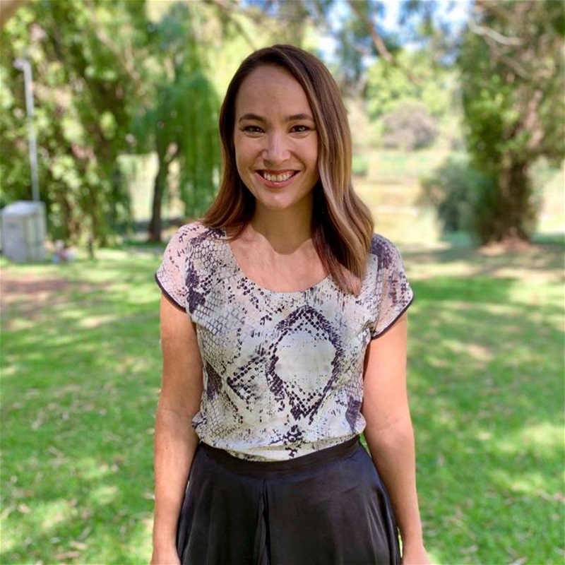 kristy woman standing in park smiling at camera