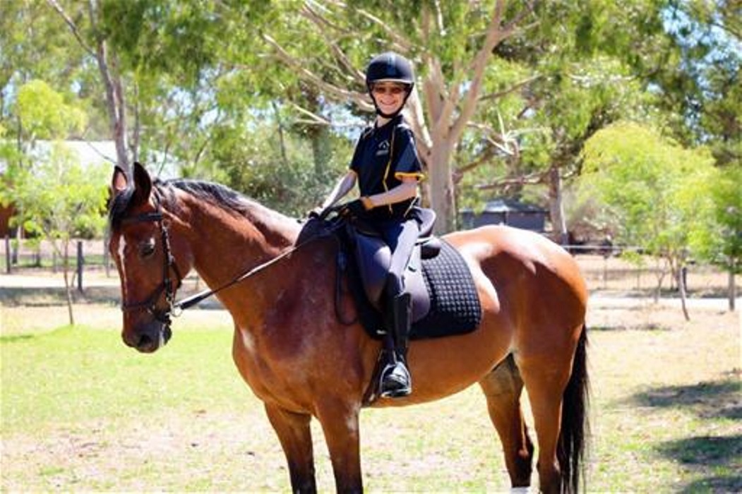 Fleur Litster on her horse Gus woman wears black riding attire as she sits on brown horse