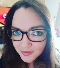 Head shot of a lady with glasses looking at the camera