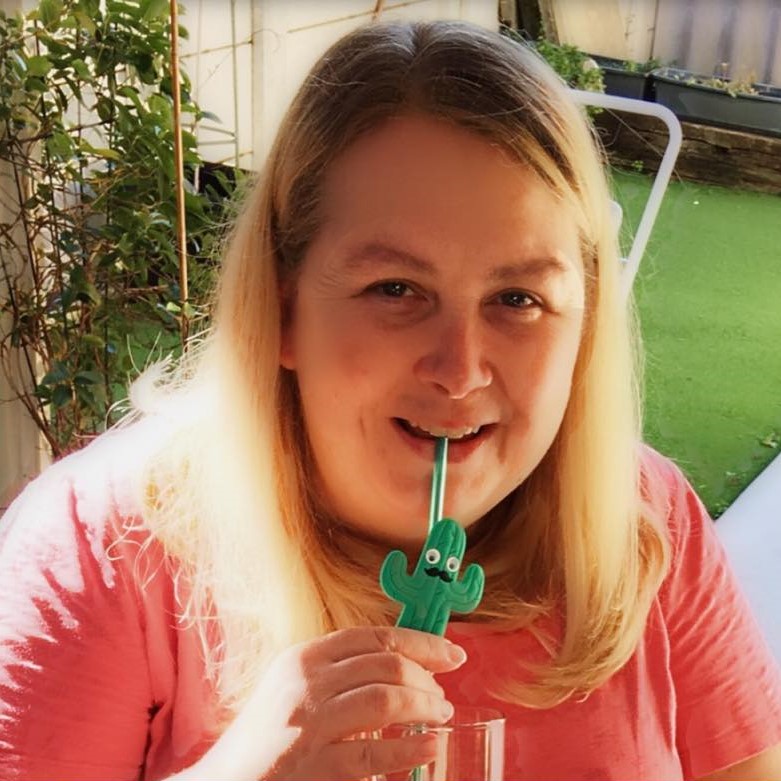 blonde woman drinking through green eco straw