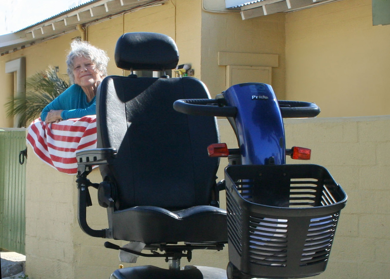 A woman gazing at a mobility scooter.