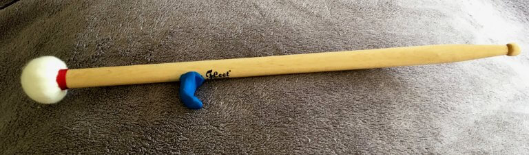 Drumstick with a piece of blue Sugru in the shape of a hook