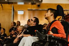 Guests at the AT Chat launch are seated side by side watching a speaker who is in front of them but out of shot