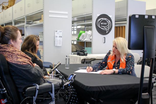 Three women work on a written document