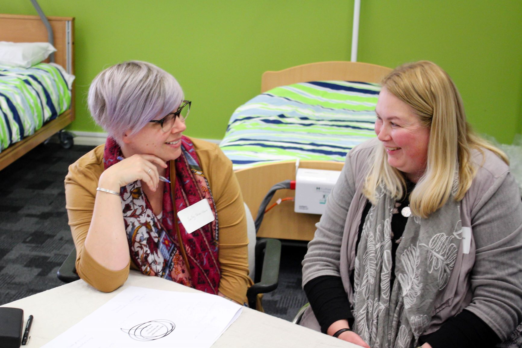 two women smile and chat