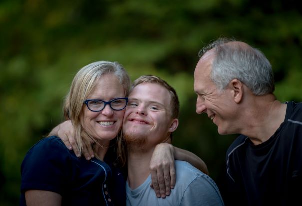 Close shot of a family smiling and hugging. Close shot of a family smiling and hugging.