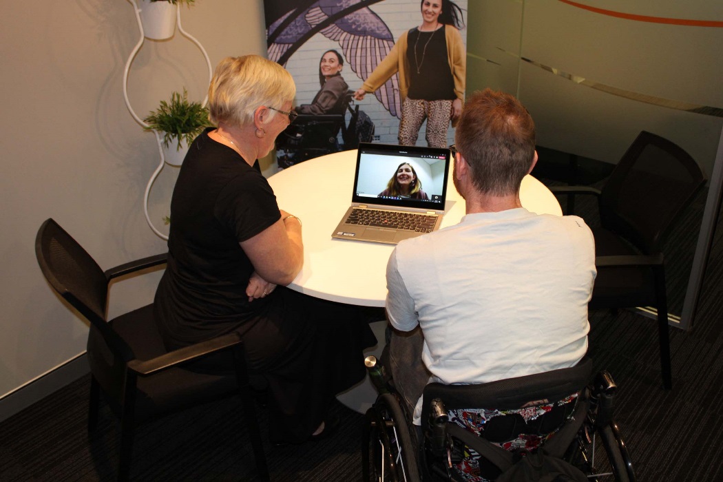 A lady and a man work together in an office environment. They are having a video call on the computer. A lady and a man work together in an office environment. They are having a video call on the computer.