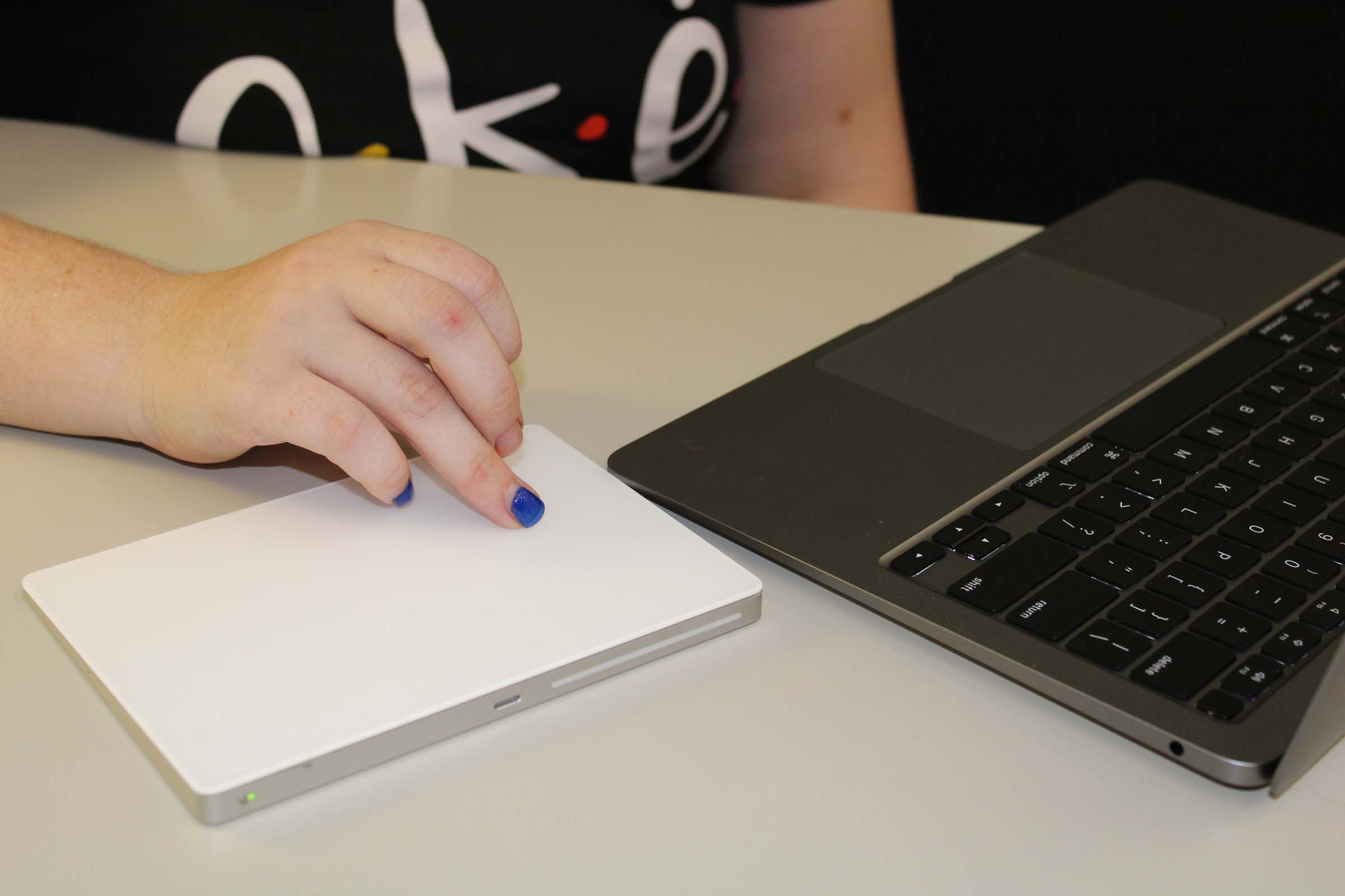 A close up shot of a hand on a trackpad. A close up shot of a hand on a trackpad.