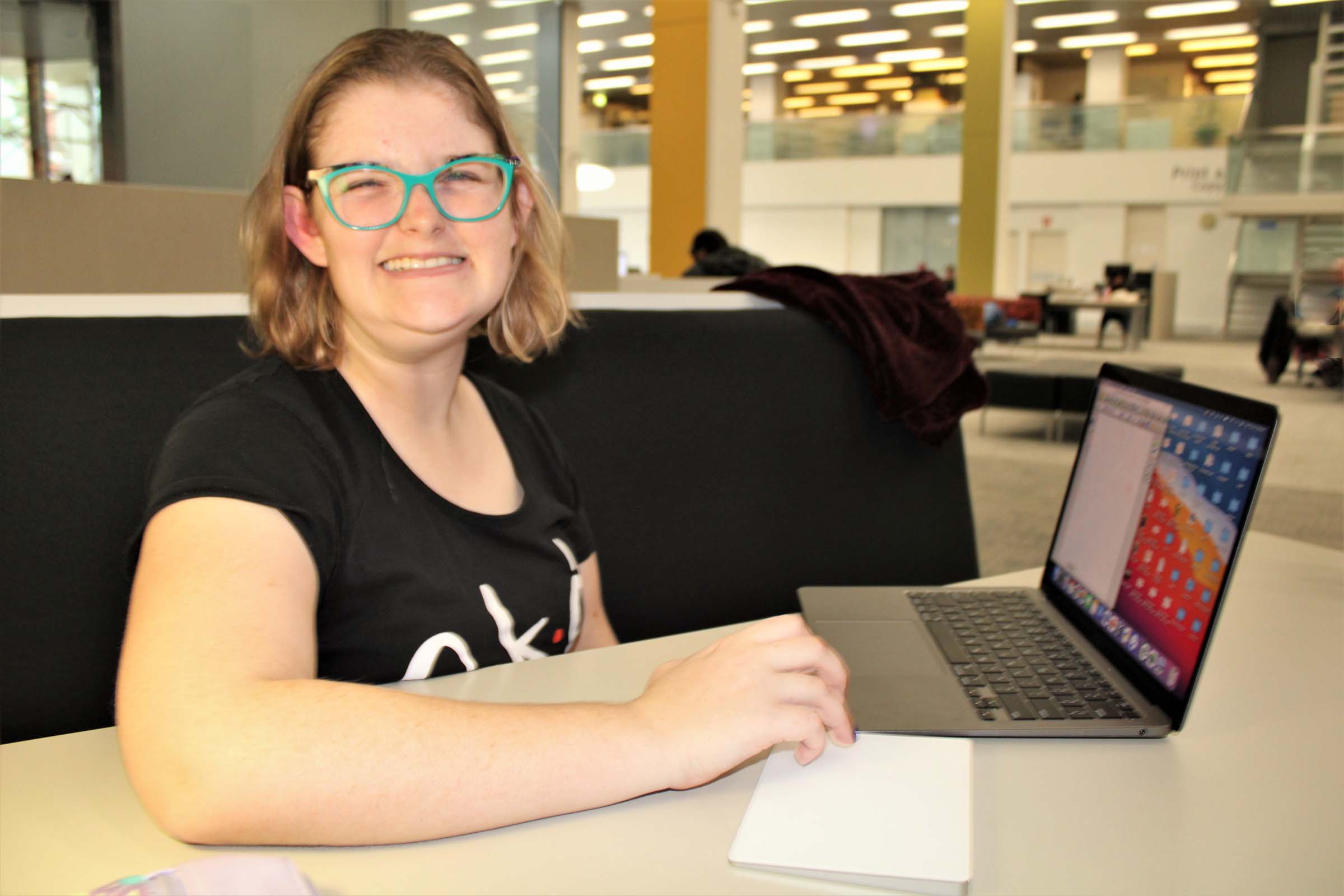 A young lady sits at a computer and works. A young lady sits at a computer and works.