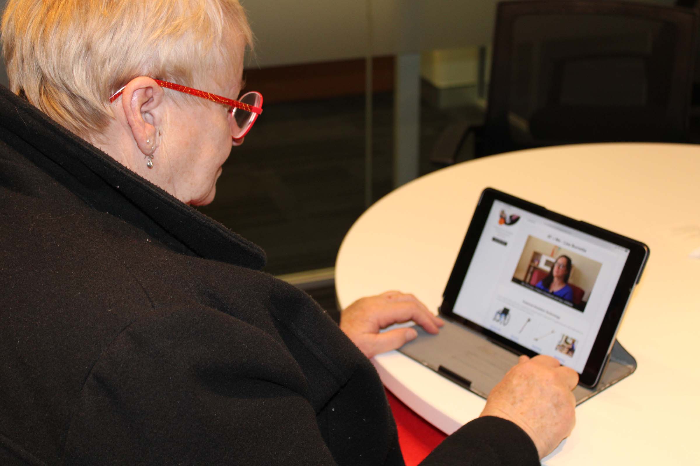 A young woman looks at a computer screen and works. A young woman looks at a computer screen and works.