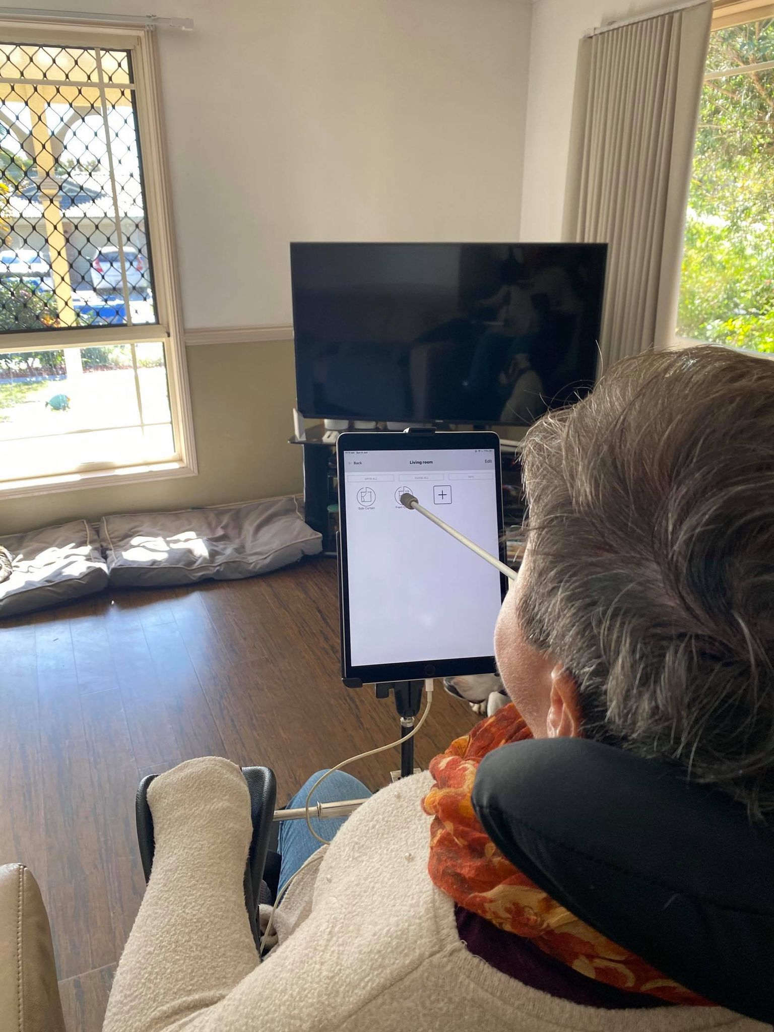 Joanna Fowler uses chin control to work her iPad in her living room. Joanna Fowler uses chin control to work her iPad in her living room.