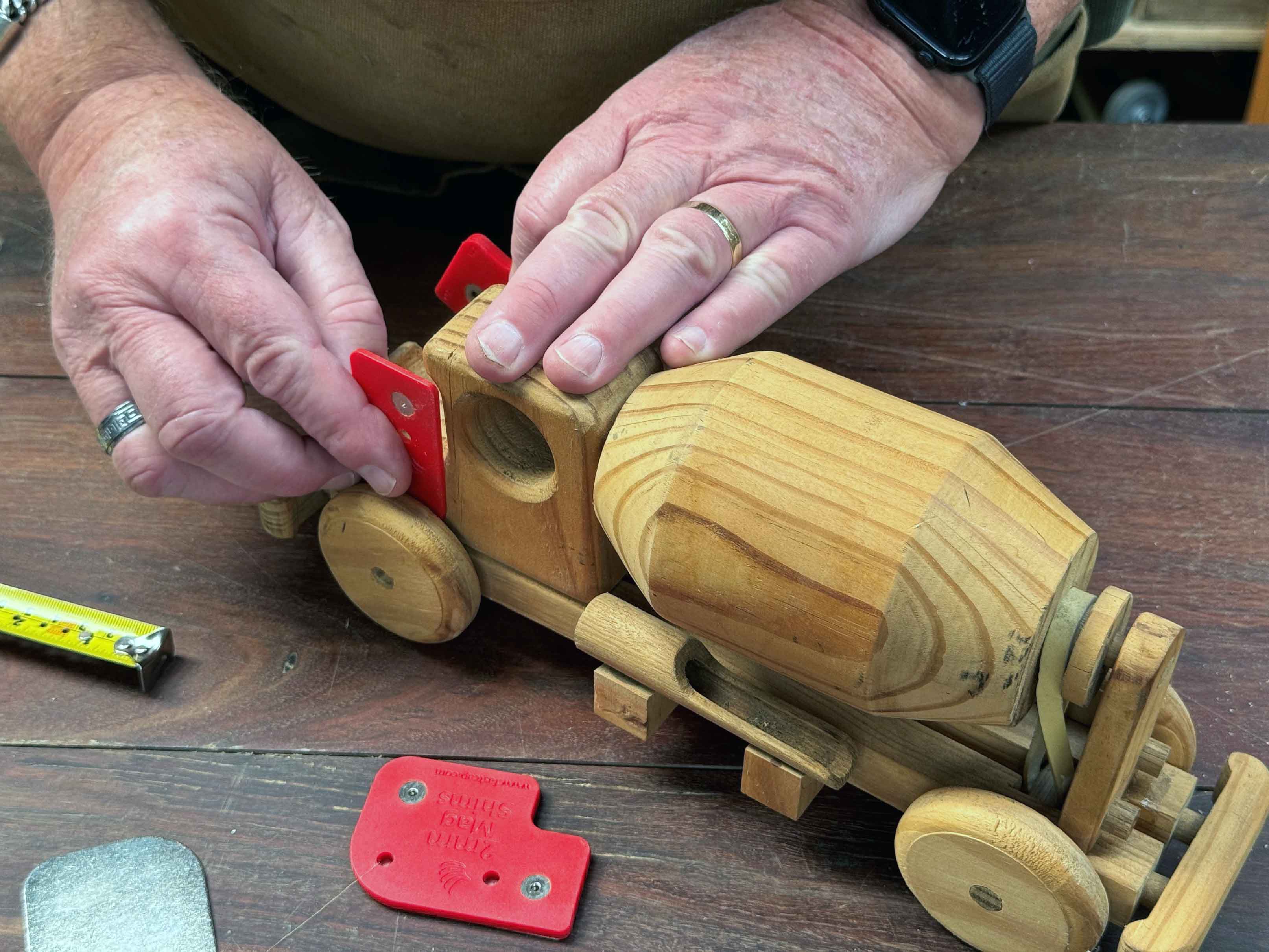 Measuring up with vision loss Mag Shim A mans hand holds a mag shim against the side of a child's toy