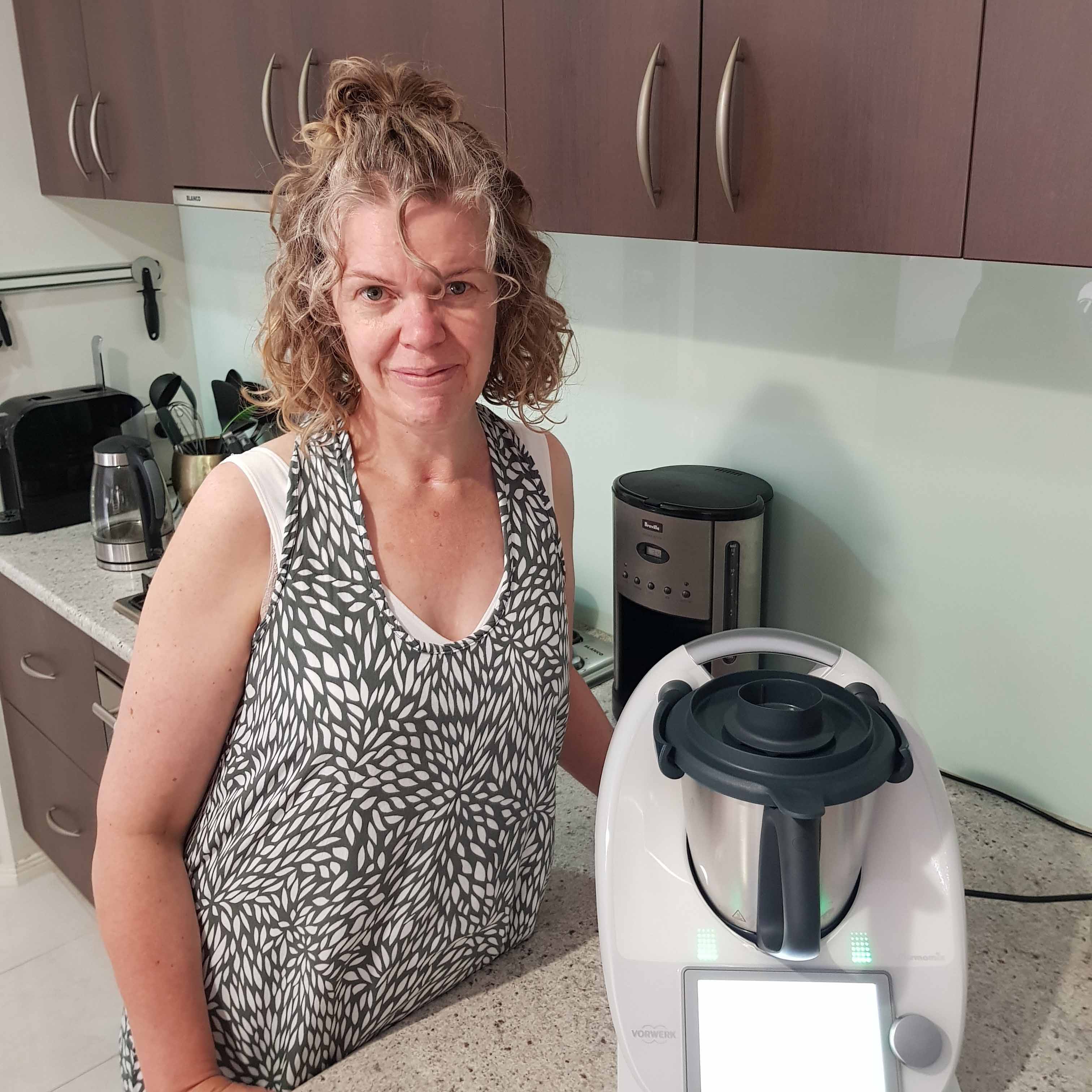 Lady standing beside her Thermomix