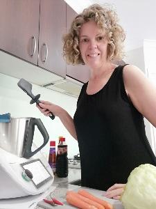 Lady standing in kitchen using a Thermomix