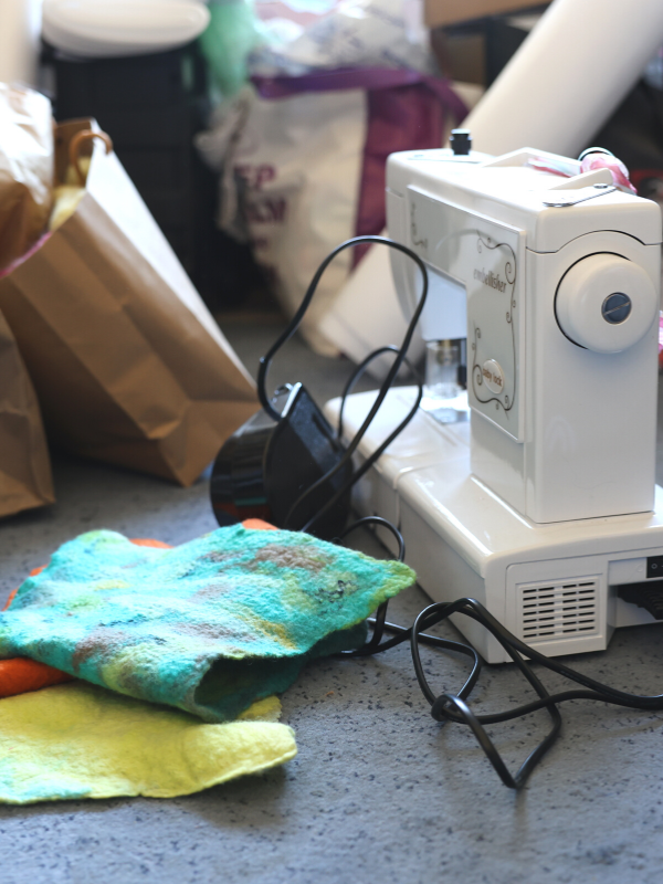 A felting machine next to felt sheets