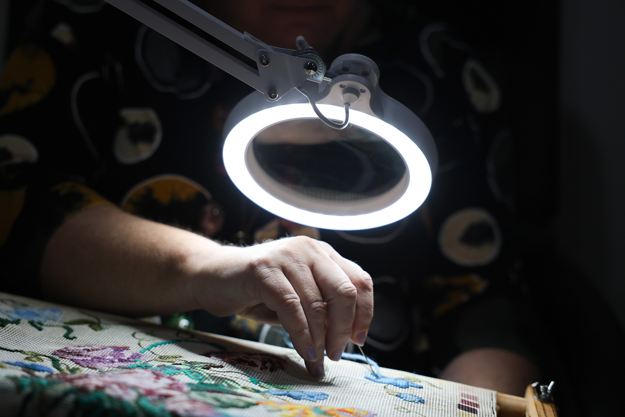 A photo of a woman's hand illuminated by a lamp