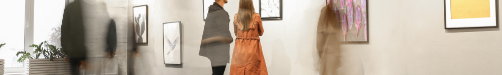 a photo of an art gallery with in focus and out of focus people