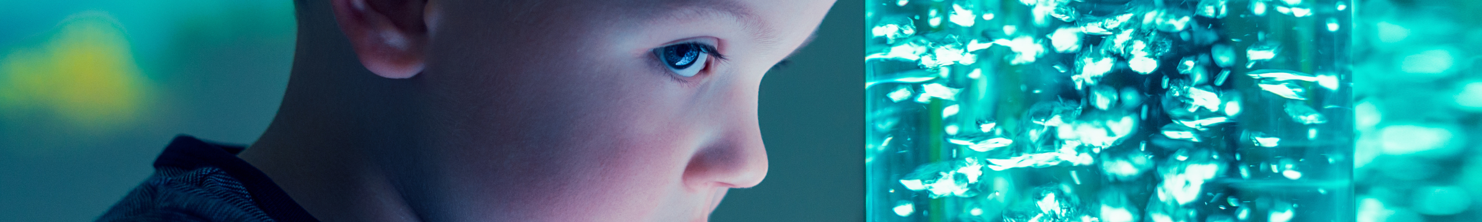 close up of a child's face next to a bubble tube