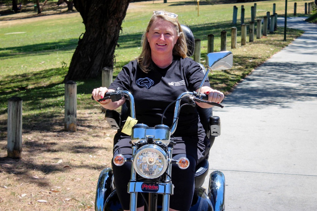 linda_resize blonde woman sits on mobility scooter that looks like a motoerbike